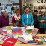 ReNae Merrill demonstartes the process to several Fabric Nook customers.