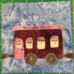 This quilt block shows a private railroad car against a light blue salmon-patterned background. It's a pretty frilly car, with a pink rooftop that has 
