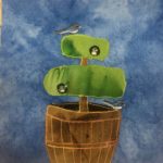 This quilt block shows a barrel made from brown boards with a dense topiary coming out of it. The topiary has been fashioned into two separate layers, with the lower layer being much larger. In this topiary are two bird heads poking out and looking around, one in the lower bush, and one in the upper bush. There is a small gray-white bird below the large layer on the barrel and a similar bird (a Junco bird) on the top topiary perching. The topiary is made of a green fabric. This is all against a blue background.