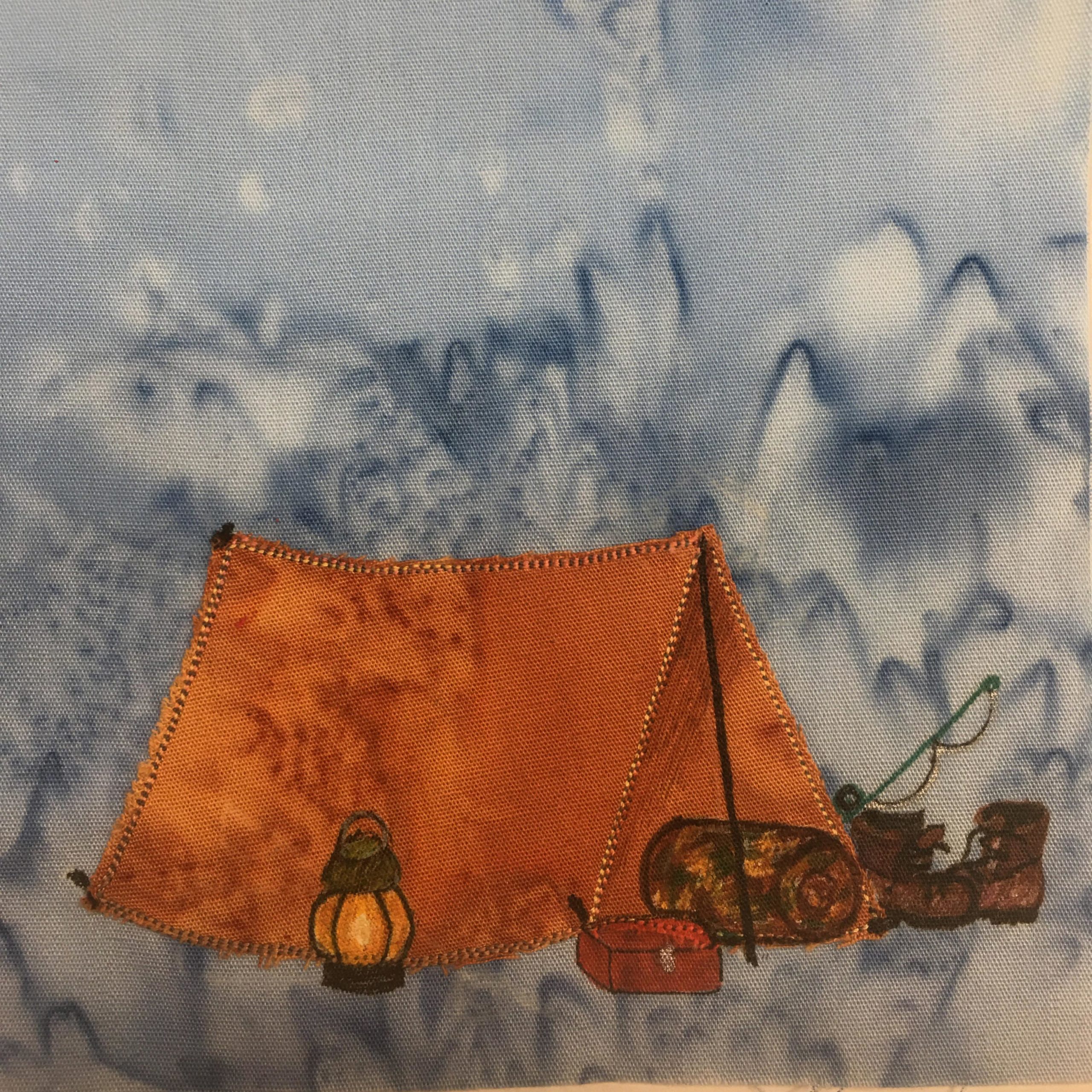 This quilt block shows an orange tent. It's a simple set up tent with two poles holding up a center rail that a blanket is laid over. There are brown steel toed red wings drawn in pen to the right side of the entrance of the tent. There's also a fishing pole above them drawn in. At the entrance of the tent is a camouflage sleeping bag rolled up (with pen markings for the camouflage). Next to the that is a red tacklebox that is drawn in with red pen. And finally to the left next to the orange tent is drawn in a lantern. This is all against a blue salmon-patterned background.