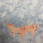 This quilt block shows two young pigs (shoats) against a blue background. The pigs themselves are a light pink color piece of fabric. There are two pigs, each facing the other direction. The left pig is sniffing the air and taking astep forward, while the other is "smiling" for the camera. Each pig is outlined by a white stitching. There are little noses and curly-q tails penned in with a brown pen.